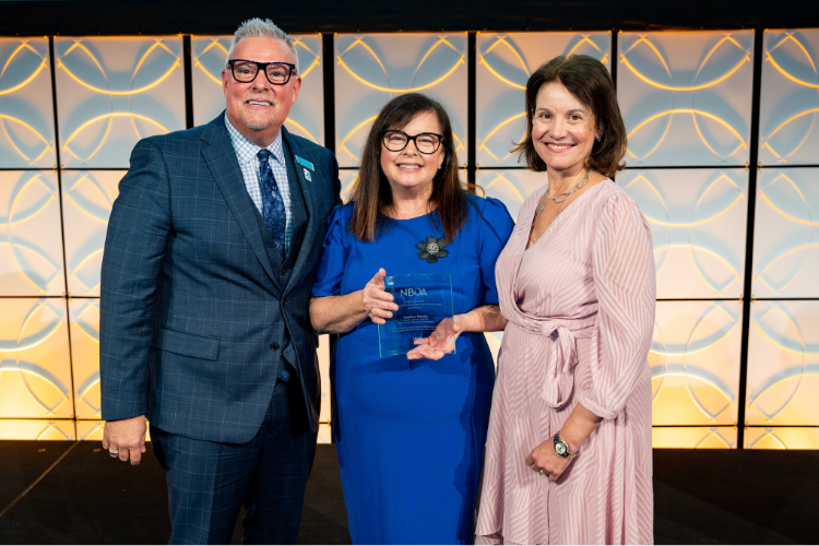 Heather Hoerle (center) accepting the  2022 Sarah Daignault Outstanding  Support for Independent Schools  Award with Shields and Rose Neubert,  the 2021–23 NBOA Board Chair.